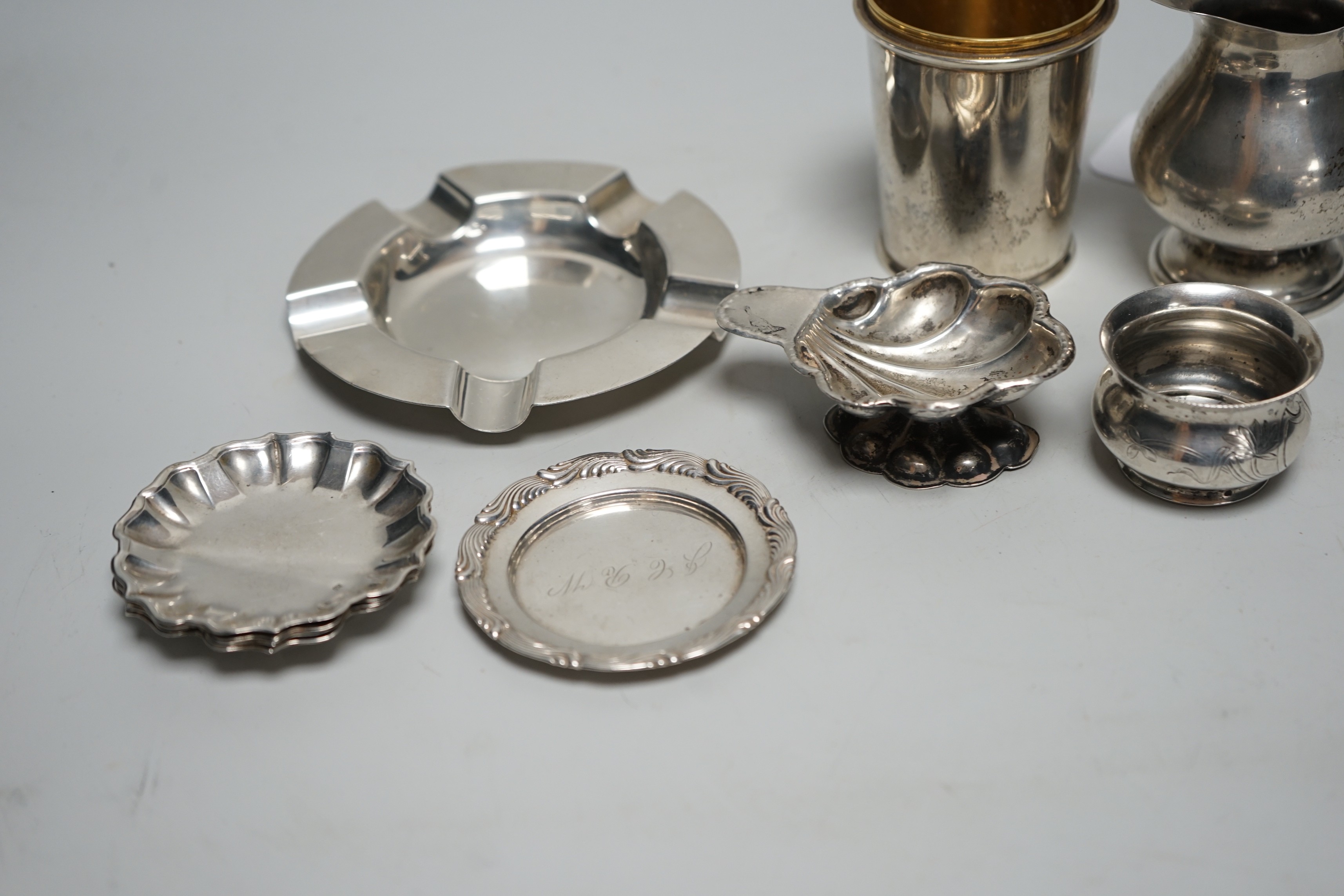 Sundry small silver, including a set of four 800 standard white metal small dishes, a similar shell salt and cream jug, a Tiffany & Co sterling small dish, a modern silver cup base (top missing), a silver ashtray and a R